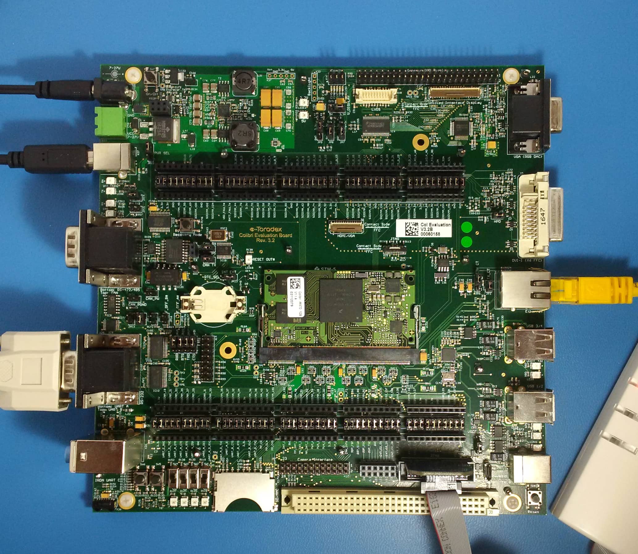 Toradex Colibri Carrier Board with Ethernet, serial, JTAG and USB cables connected.